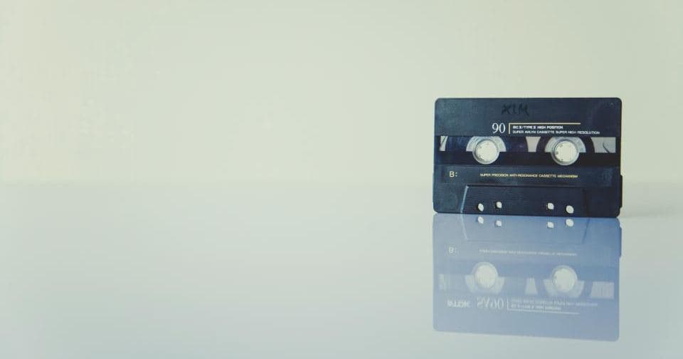 Cassette tape standing on a reflective desk