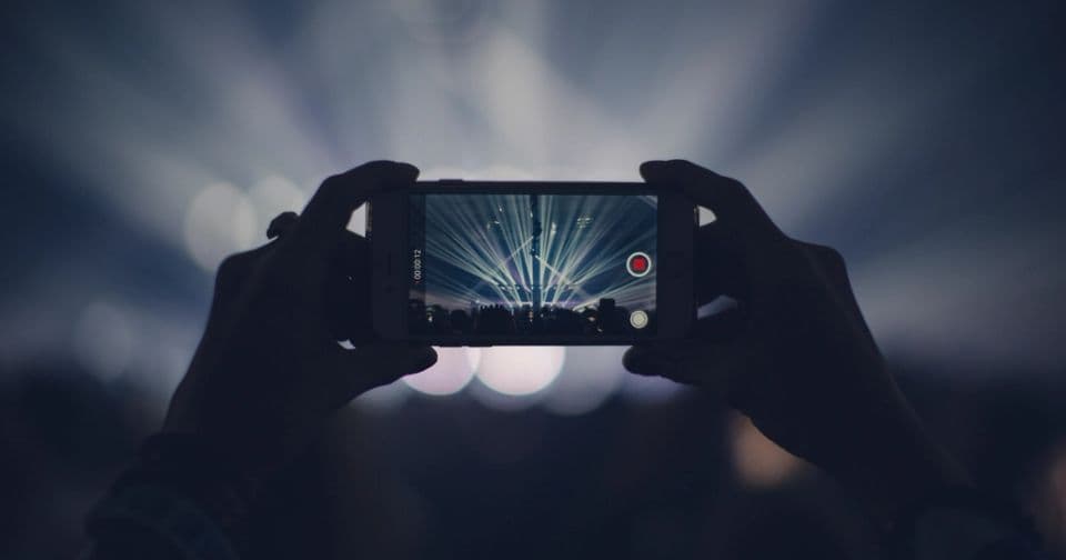 Hands holding a smartphone recording a video