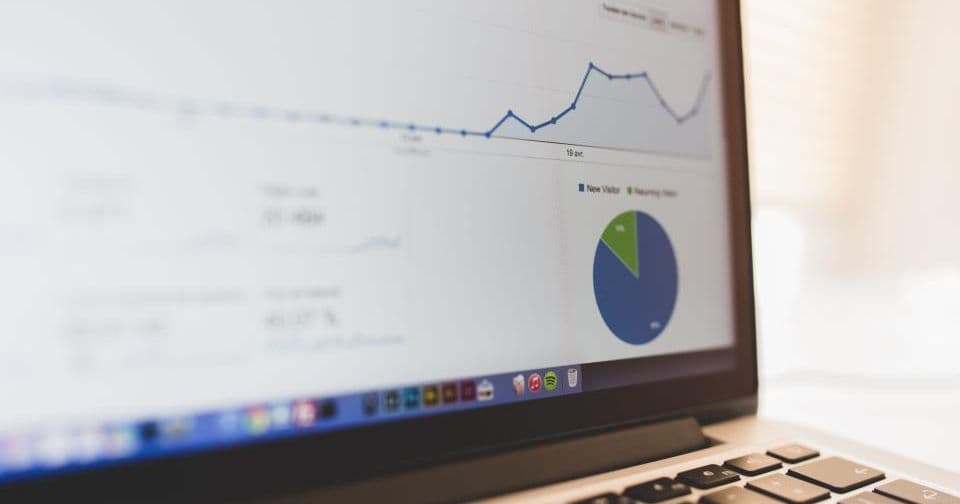 Laptop showing a website analytics dashboard with a traffic chart