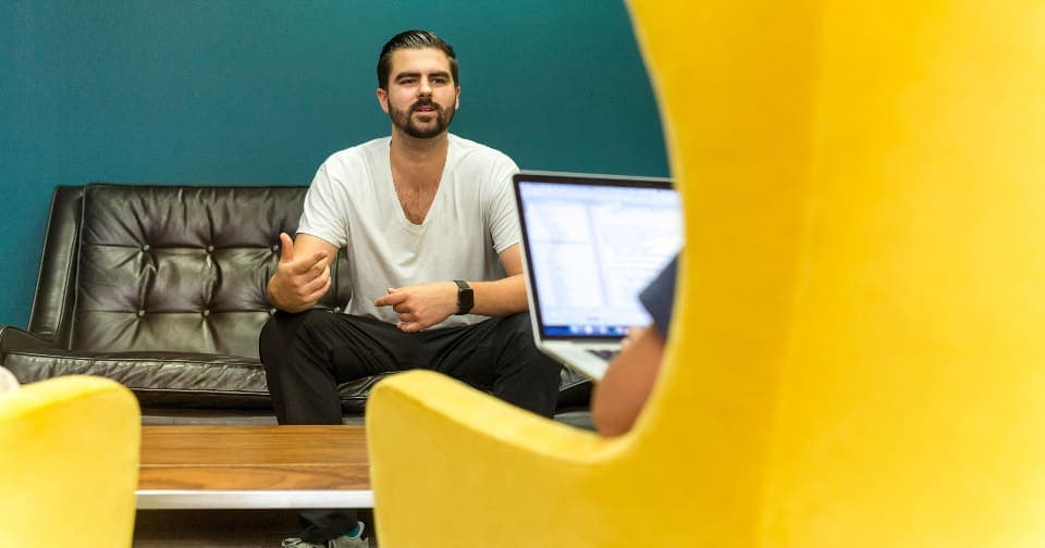 Founder answering questions in a relaxed office interview
